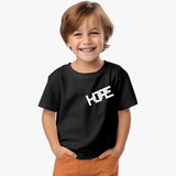 A young boy wearing a black crew neck t-shirt with the word 'HOPE' printed on the front in white letters.