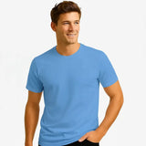 Man wearing a light blue t-shirt against a plain background