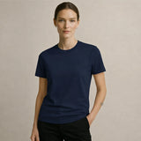 Woman wearing a navy blue t-shirt against a beige background