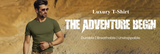 Man wearing a green t-shirt with desert background and text 'Luxury T-Shirt The Adventure Begin'.